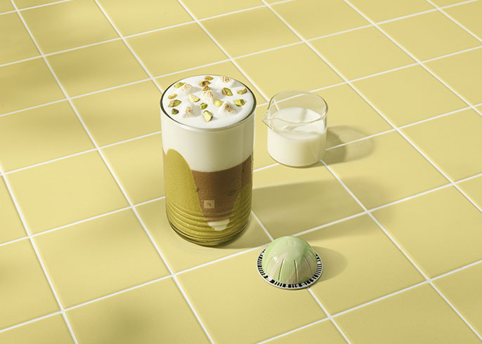 Coffee cup with pistachio color and pistachio capsule